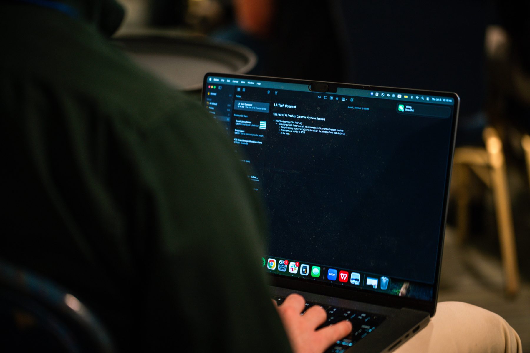An attendee working on a laptop during the 2025 workshop